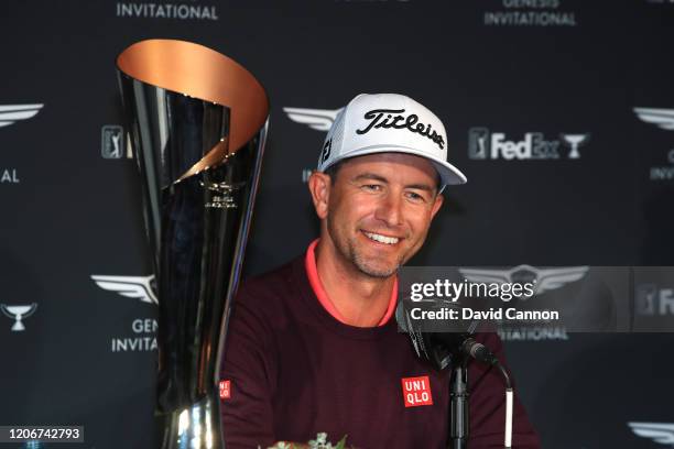 Adam Scott of Australia sits beside the trophy as her speaks to the media after his two shot win during the final round of the Genesis Invitational...