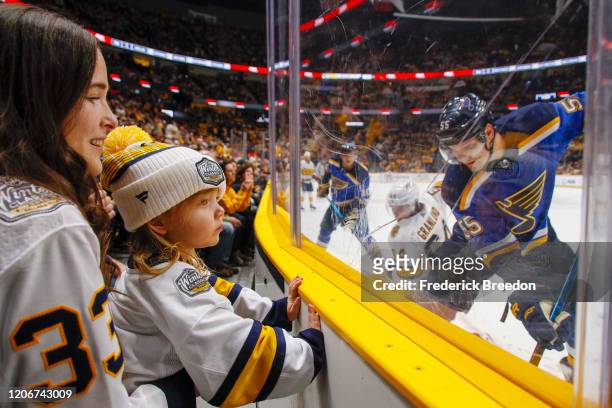 Mother and a young fan of the Nashville Predators watch during the third period of a 2-1 Predators victory over the St. Louis Blues at Bridgestone...