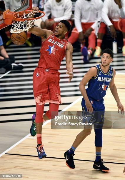 Giannis Antetokounmpo of Team Giannis dunks the ball past Devin Booker of Team LeBron in the first quarter during the 69th NBA All-Star Game at the...