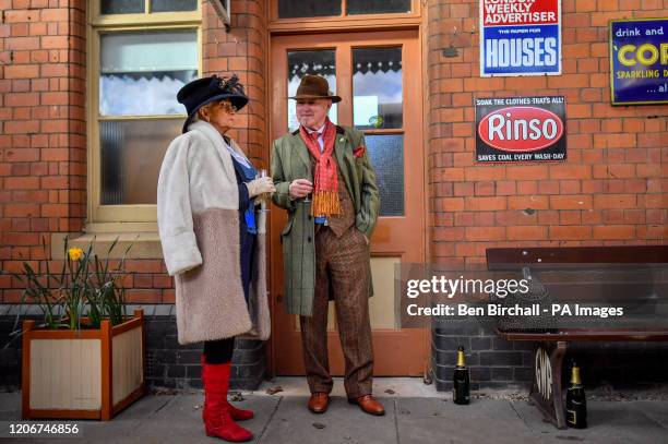 Racegoers dress up at Toddington station, Gloucestershire, where they are catching a steam train service to Cheltenham races that is running during...