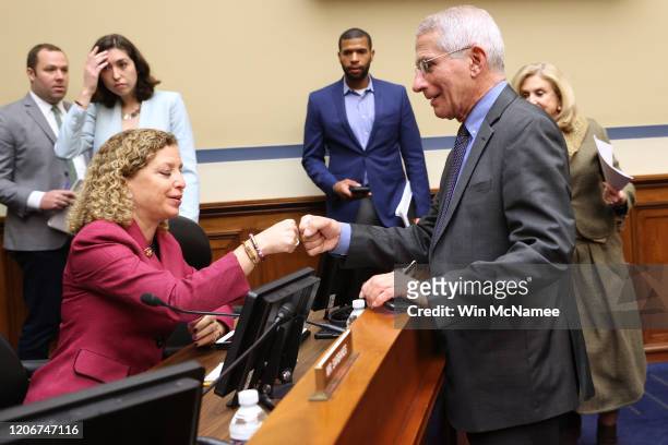 Anthony Fauci, director of the NIH National Institute of Allergy and Infectious Diseases fist bumps Rep. Debbie Wasserman Schultz during a House...