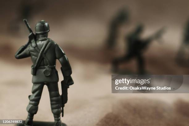 toy army soldier on the battlefield - battlefield stock pictures, royalty-free photos & images