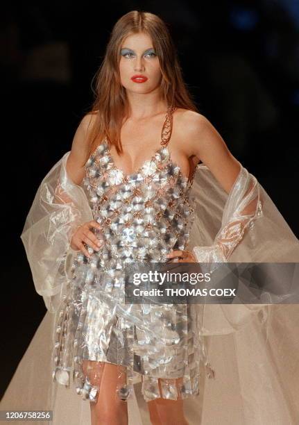 French model Laetitia Casta presents a short silvery link dress with a beige tulle coat 09 July in Paris during the Paco Rabanne 1997/98 Fall/Winter...