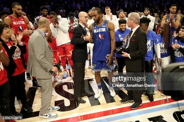 Commissioner Adam Silver congratulates Kawhi Leonard of Team LeBron after being named the Kobe Bryant MVP during the 69th NBA All-Star Game at the...