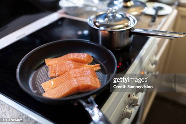 cooking salmon in the domestic kitchen - filete de salmón fotografías e imágenes de stock