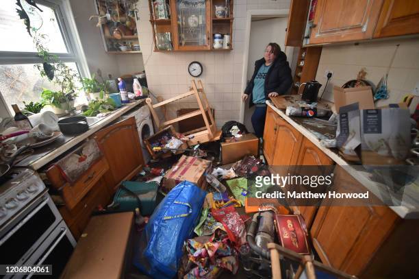 Rachel Cox stands among debris left inside her house after the floodwaters receded on Oxford Street on February 17, 2020 in Nantgarw, United Kingdom....