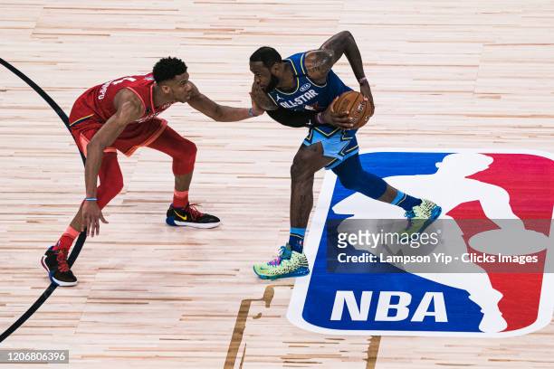 LeBron James of Team LeBron handles the ball against Giannis Antetokounmpo of Team Giannis during the 69th NBA All-Star Game on February 16, 2020 at...
