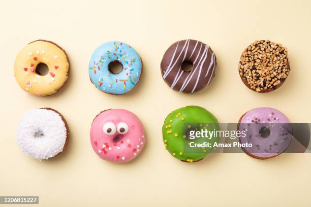 top-ansicht des satzes von donuts auf gelbem hintergrund. flachliegen, kopierraum. - krapfen und doughnuts stock-fotos und bilder