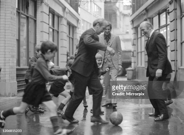 British soccer player Bobby Charlton is chased in the street by children of Dounside Purley School in Surrey watched by England manager Sir Matt...