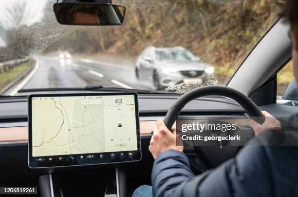 tesla model 3 - interior view - steering wheel logo stock pictures, royalty-free photos & images