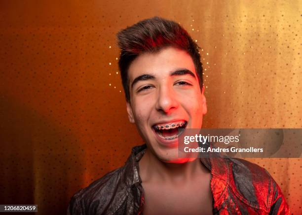 young happy teenager with brakets - macho fotografías e imágenes de stock