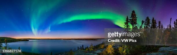 The arc of Northern Lights starting a show in the deep twilight over Prelude Lake on the Ingraham Trail near Yellowknife, NWT. This was September 9,...