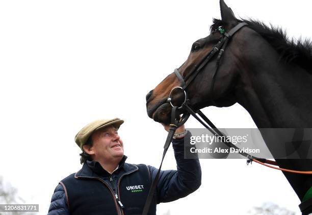 Trainer Nicky Henderson poses for a photo with Altior, hopeful for the Betway Queen Mother Champion Chase during a Nicky Henderson Stable Visit at...