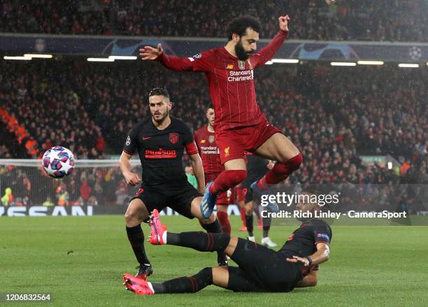 Liverpool's Mohamed Salah is tackled by Atletico Madrid's Renan Lodi during the UEFA Champions League round of 16 second leg match between Liverpool...