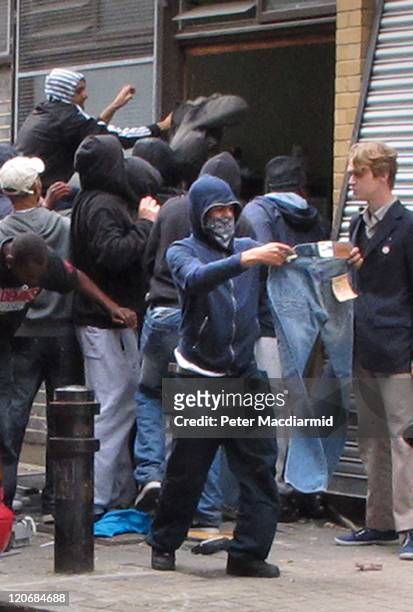 Youths loot a Carhartt store in Hackney on August 8, 2011 in London, England. Pockets of rioting and looting continues to take place in various parts...