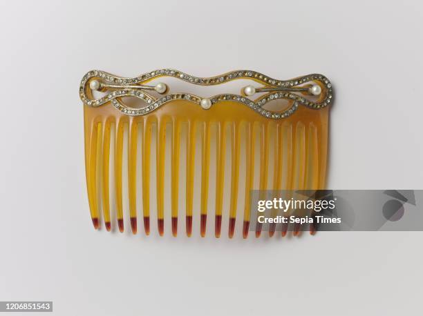 Hair comb made of plastic, with a spine on which pearls and rhinestones, Hair comb made of orange-yellow plastic, with a decorative spine, trimmed...
