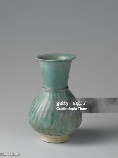 Fluted pear-shaped ewer with a turquoise glaze, Can of quartz fryer with a ribbed, pear-shaped body covered with a monochrome green-turquoise...