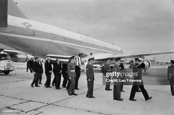 The flag-draped coffin of American politician and diplomat Adlai Stevenson II is ceremonially carried to the Presidential aircraft at London Airport...