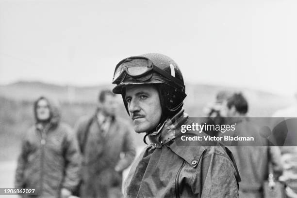 British Formula One racing driver Graham Hill wearing a head and neck support device during practice ahead of the 1965 Grand Prix of the Netherlands,...