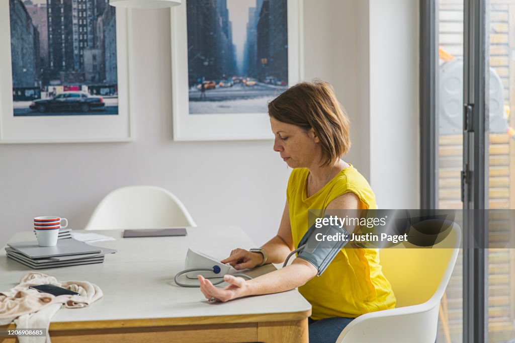 Woman checking blood pressure