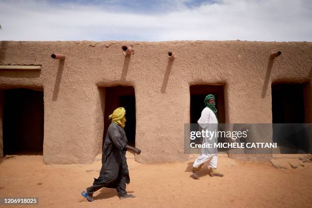 Malian faithfuls walk in the courtyard of the Tomb of Askia in Gao on March 10, 2020. - The site, which was protected during the 10 months of...