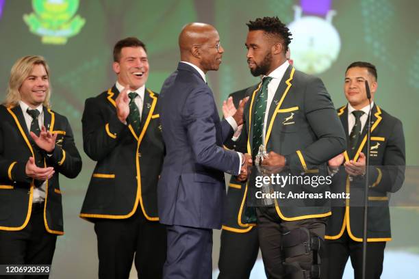 Laureus Academy member Edwin Moses presents Captain of the South Africa Men's Rugby Team Siya Kolisi with the Laureus World Team of the Year award on...