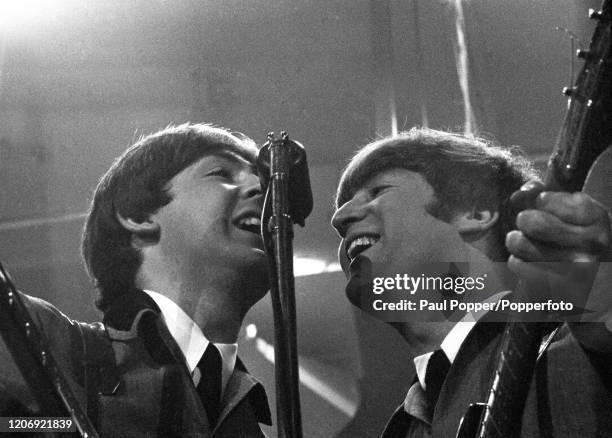 Of the Beatles performing on stage at the Washington Coliseum, Washington DC, February 11, 1964. The performance was their first US concert, coming...