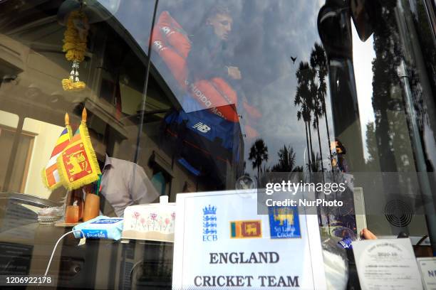 England cricket team's captain Joe Root is seen through the reflection on the front windshield glass after getting in to the bus following the the...