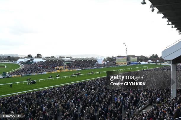 Racegoers attend the JCB Triumph Hurdle race during the final day of the Cheltenham Festival horse racing meeting at Cheltenham Racecourse in...