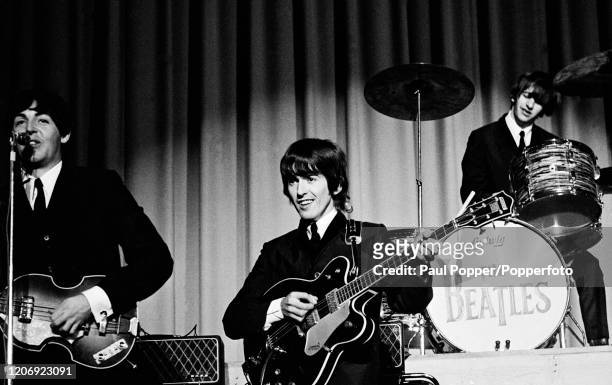 Paul McCartney, George Harrison and Ringo Starr of the Beatles performing on stage during their concert at the Baltimore Civic Center in the USA on...