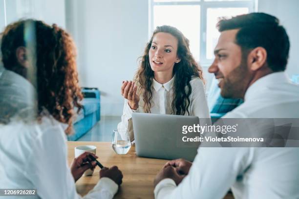 lawyer on a meeting with young couple. - women talking in a bank with computer stock pictures, royalty-free photos & images