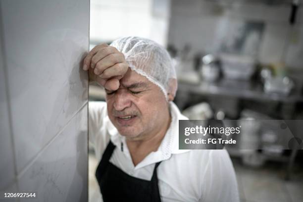 worried chef at industrial kitchen in restaurant - poor kitchen stock pictures, royalty-free photos & images