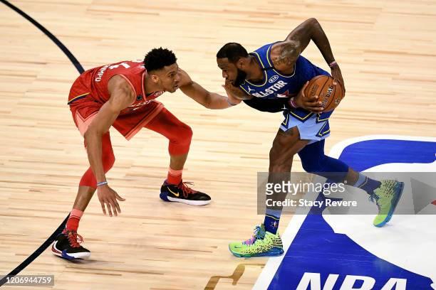 LeBron James of Team LeBron handles the ball while being guarded by Giannis Antetokounmpo of Team Giannis in the fourth quarter during the 69th NBA...