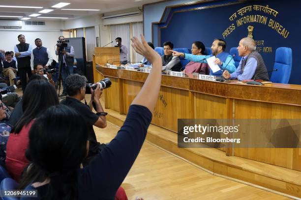 Prakash Javadekar, India's environment minister, second right, takes a question from members of the media during a news conference in New Delhi,...