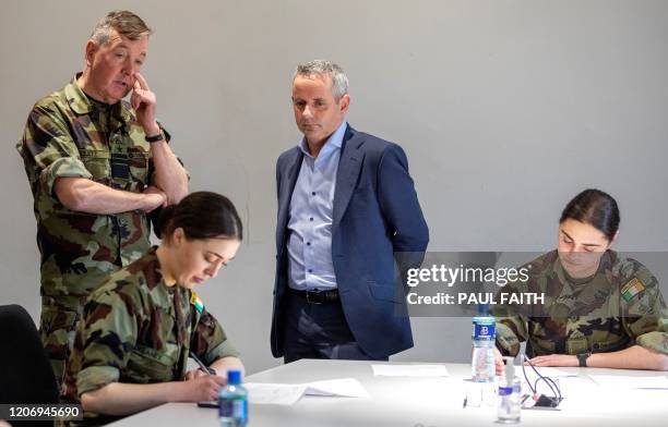 Chief of Staff of Ireland's Defence Forces, Vice Admiral Mark Mellett and CEO of Health Service Executive , Paul Reid talk to Irish Army cadets who...