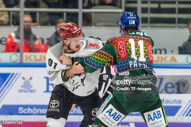 Moritz Mueller of Koelner Haie and Adam Payerl of Augsburger Pantherfighting during the DEL match between Augsburger Panther and Koelner Haie at...