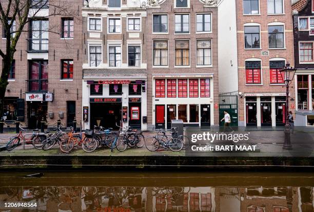 This picture taken on March 13 shows the a street in the Red Light District, in Amsterdam, the Netherlands. - To prevent the further spread of the...