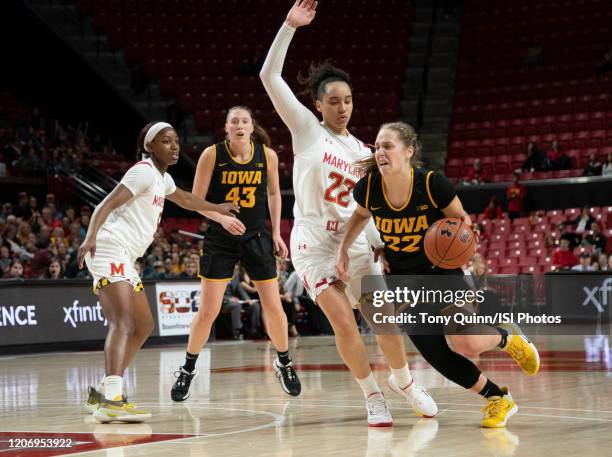 Kathleen Doyle of Iowa pushes her way past Blair Watson of Maryland during a game between Iowa and Maryland at Xfinity Center on February 13, 2020 in...
