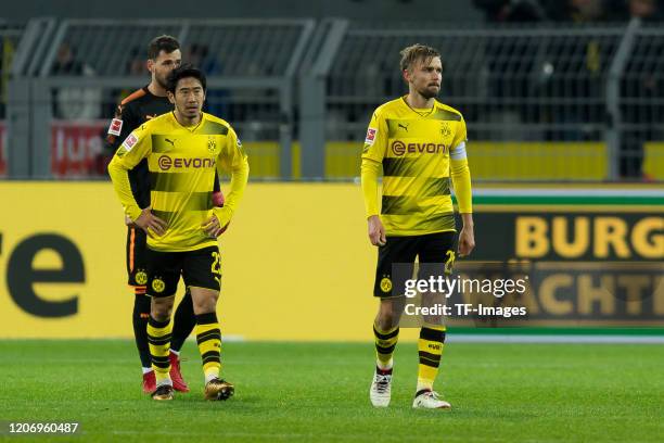 Shinji Kagawa of Borussia Dortmund and Marcel Schmelzer of Borussia Dortmund look dejected after the Bundesliga match between Borussia Dortmund and...
