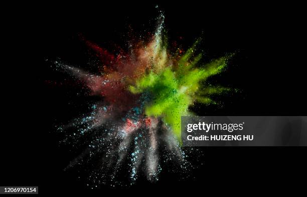 colored powder explosion on black background. colored dust explosion - powder throw stock-fotos und bilder