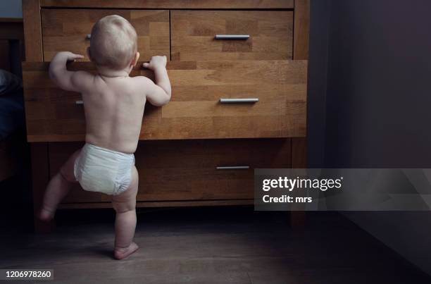 curious baby - chest of drawers stock pictures, royalty-free photos & images