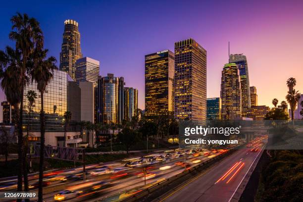 busy traffic in downtown los angeles at dusk - downtown district stock pictures, royalty-free photos & images