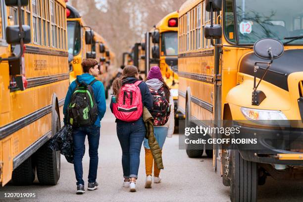 High school students leave Beal Secondary School in London, Ontario on March 13, 2020 on their last day of classes before a 3 week break imposed by...