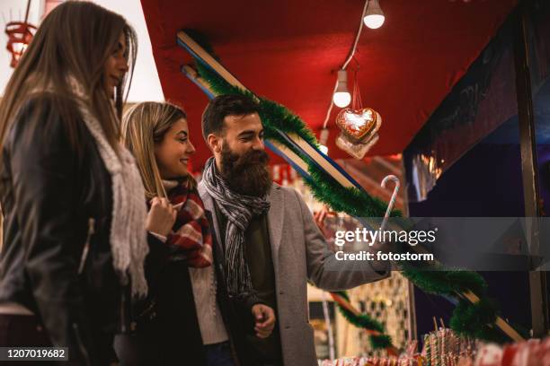 selecting the best candy cane with friends - novi sad stock pictures, royalty-free photos & images