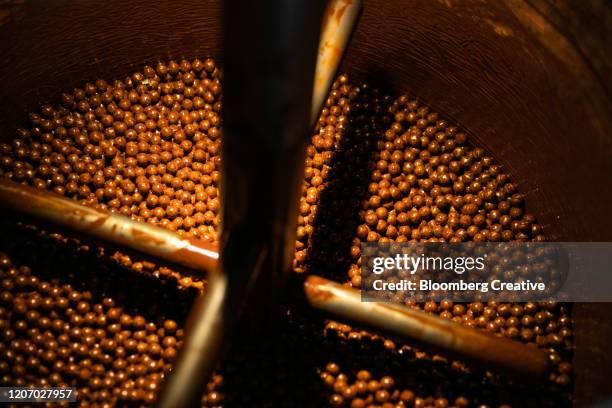 chocolate balls on a production line - candy factory stockfoto's en -beelden