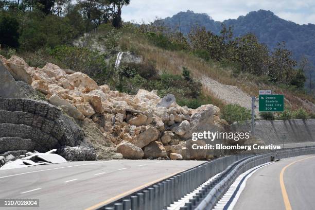 rock landslide across a major road - deslizamiento de tierras fotografías e imágenes de stock