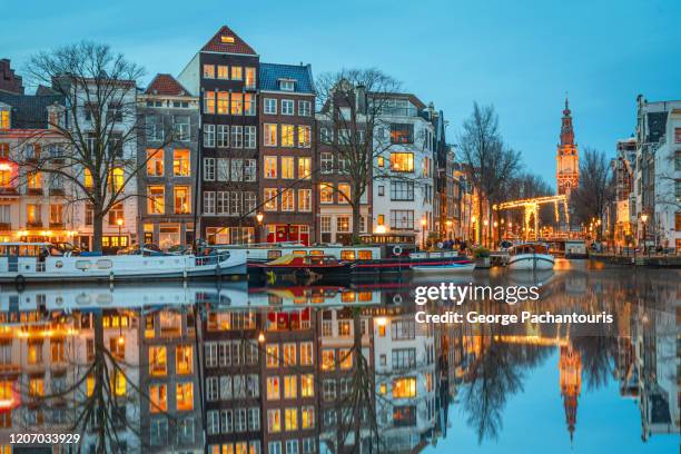 beautiful reflection in amsterdam canals at dusk - amsterdam stock-fotos und bilder