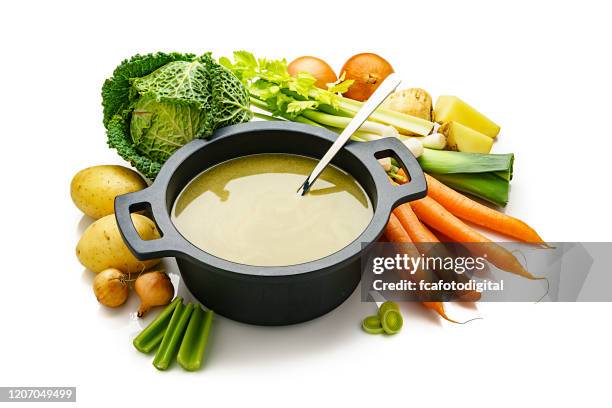 vegetables broth in a cooking pan isolated on white background - celery soup stock pictures, royalty-free photos & images