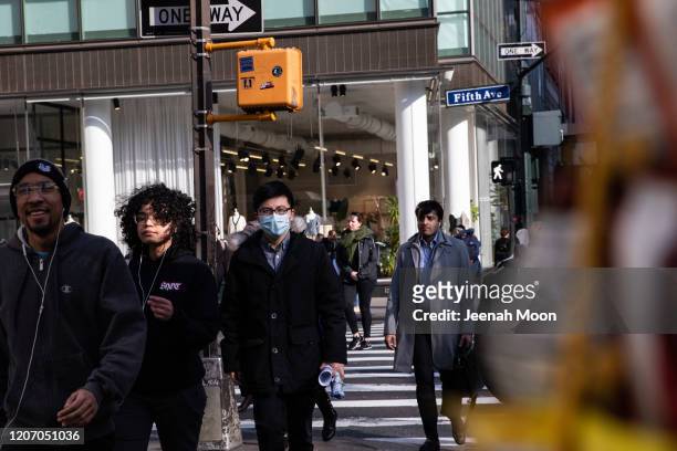 Man wearing a protective mask walks on the street on March 13, 2020 in New York City. President Donald Trump is expected to declare national...