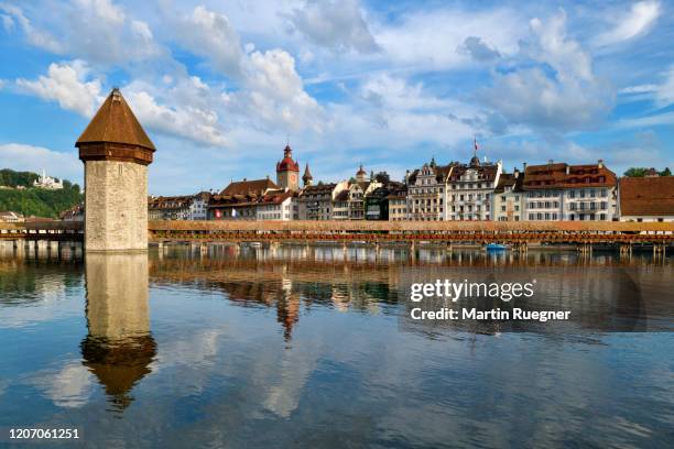 the famous wooden kapellbrücke spanning across the reuss river, in the city of lucerne. - chapel bridge stock pictures, royalty-free photos & images